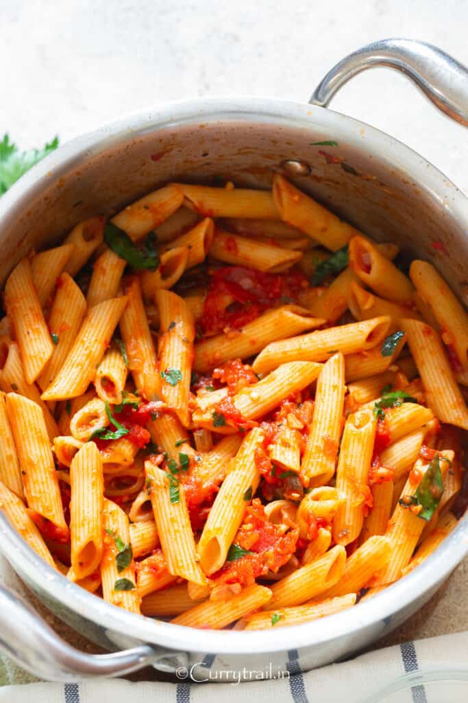 penne pasta with arrabbiata sauce in pan