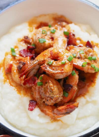 close up view of cajun shrimp on white grits