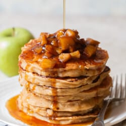 stacks of apple pancake with cinnamon apples with maple syrup