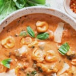 creamy tomato tortellini soup with text