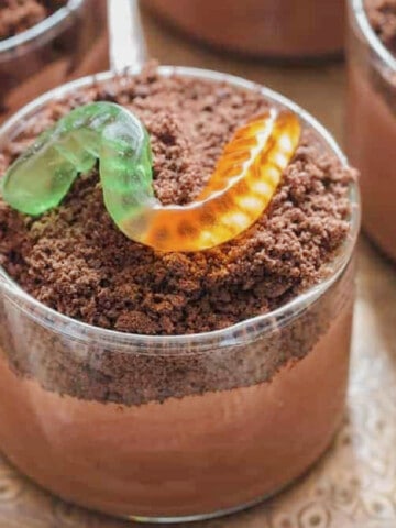 cups with chocolate pudding and gummy candies
