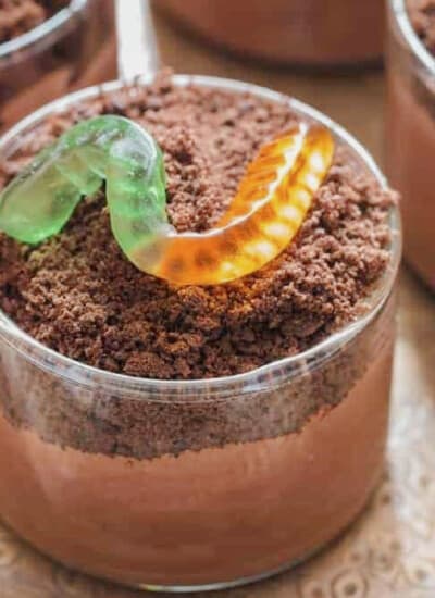 cups with chocolate pudding and gummy candies