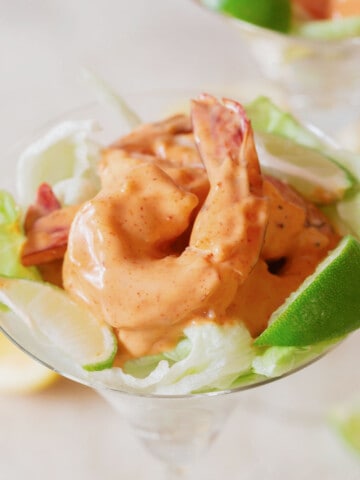 Spicy prawn cocktail is a classic starter dish in which juicy prawns are tossed in pink Marie Rose sauce with an added punch. A classic 70's starter dish that never goes out of style. You can serve it as a starter like bang bang shrimp, or as salad, or along with any main dish. 