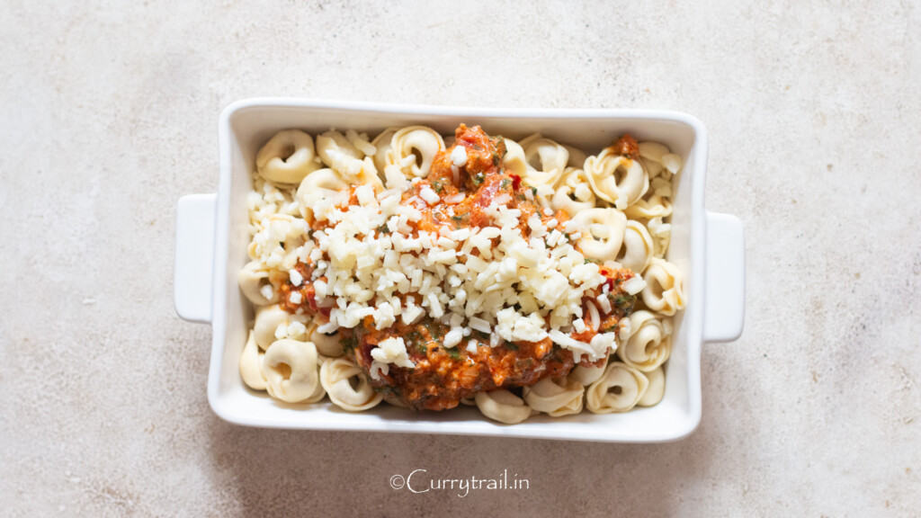 shredded Mozzarella cheese sprinkled on top in a casserole dish.