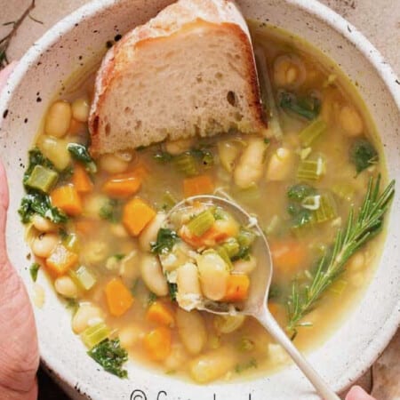 white bean soup in a bowl with bread toast.