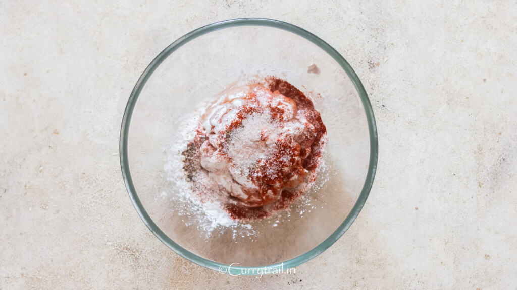 cubes of chicken coated in flour, paprika salt, and pepper.