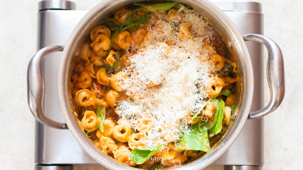 grated Parmesan added to Marry Me chicken tortellini.