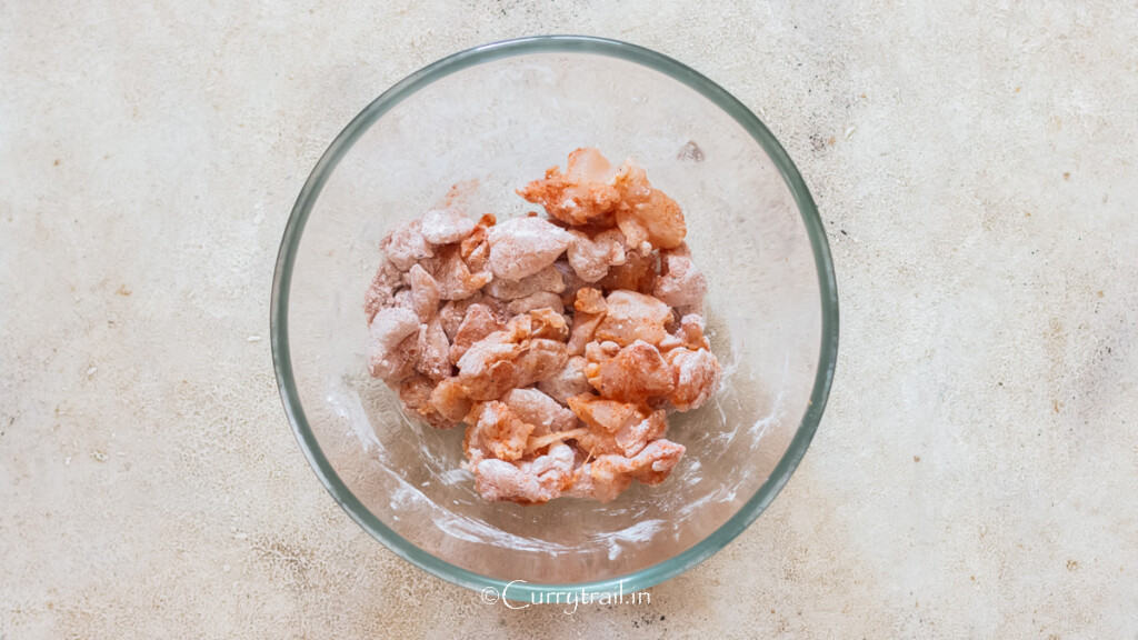 cubes of chicken coated in flour, paprika salt, and pepper.