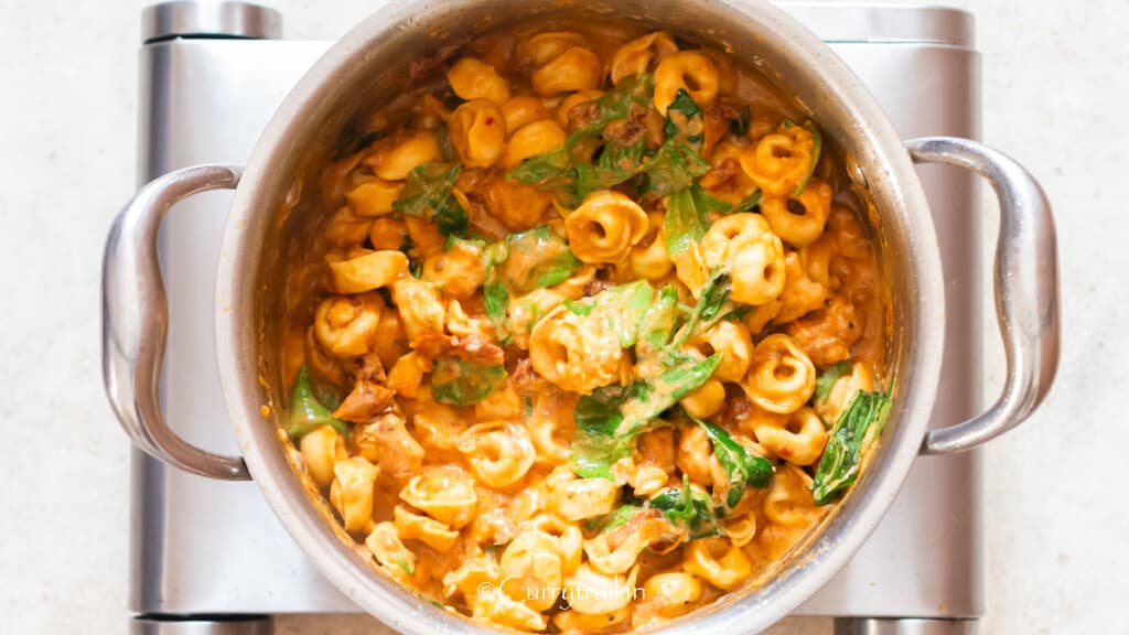 Marry Me chicken tortellini cooked in a pot.