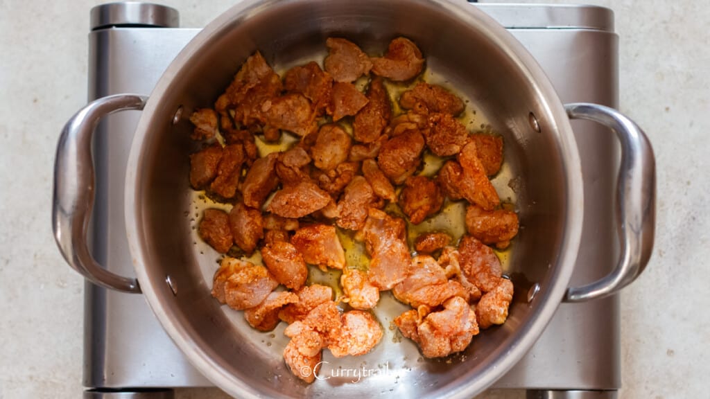 pan searing flour-coated chicken in a pan.