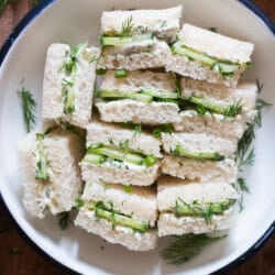 mini tea sandwiches arranged on a plate.