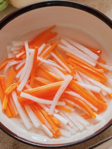 carrot and daikon matchsticks pickled in vinegar.