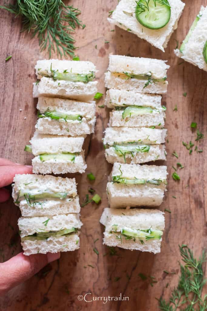 small tea sandwiches with cucumber slices and cream cheese filling.