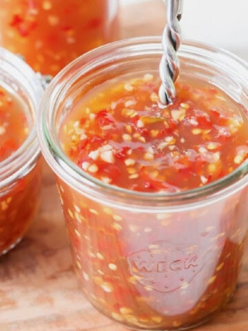 Asian spicy sweet chili sauce in 3 glass jars.