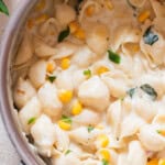 shell pasta and sweet corn cooked in a creamy sauce in a pot.