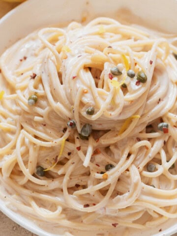 Lemon pasta in a creamy sauce on a plate.