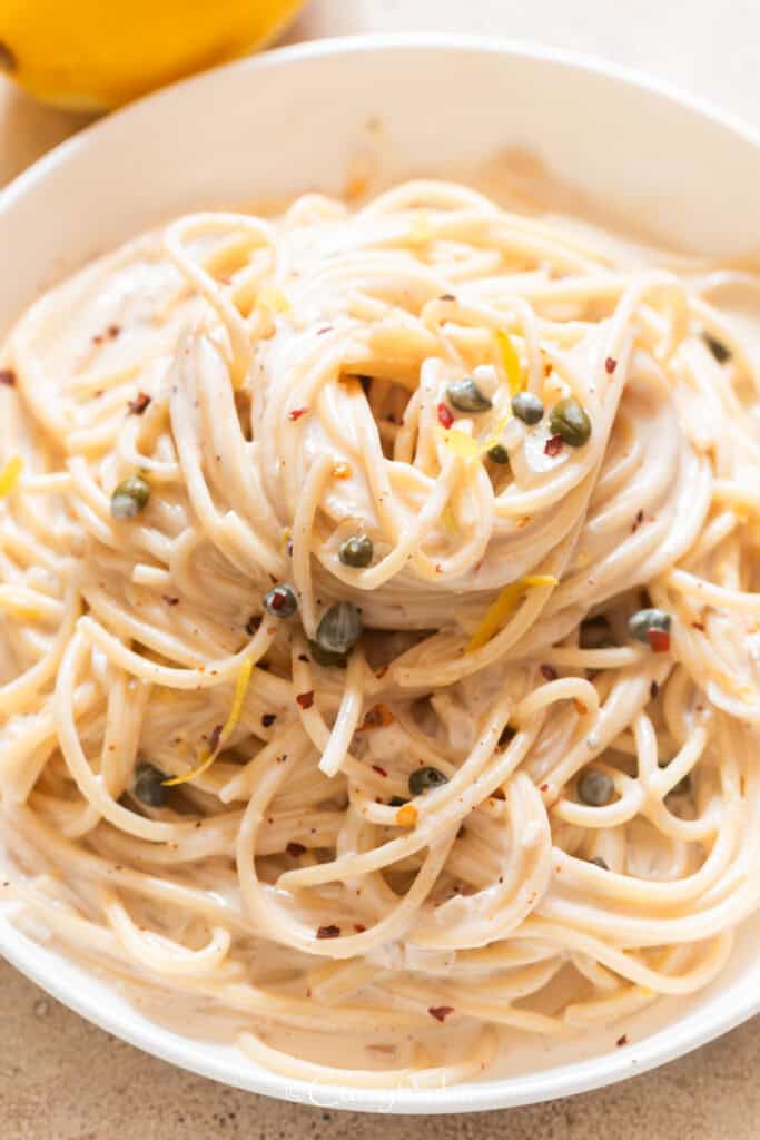Lemon pasta in a creamy sauce on a plate.