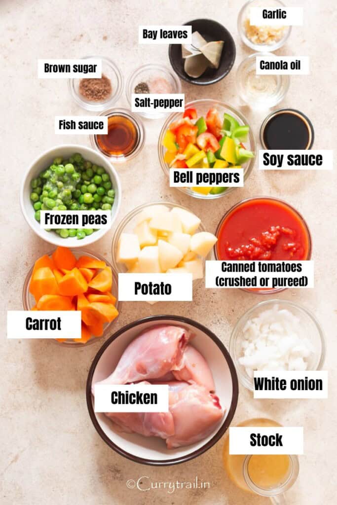 all ingredients for chicken afritada arranged on a table.