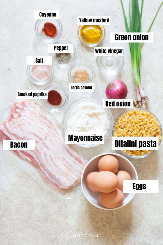 all ingredients for deviled egg pasta salad arranged on a table.