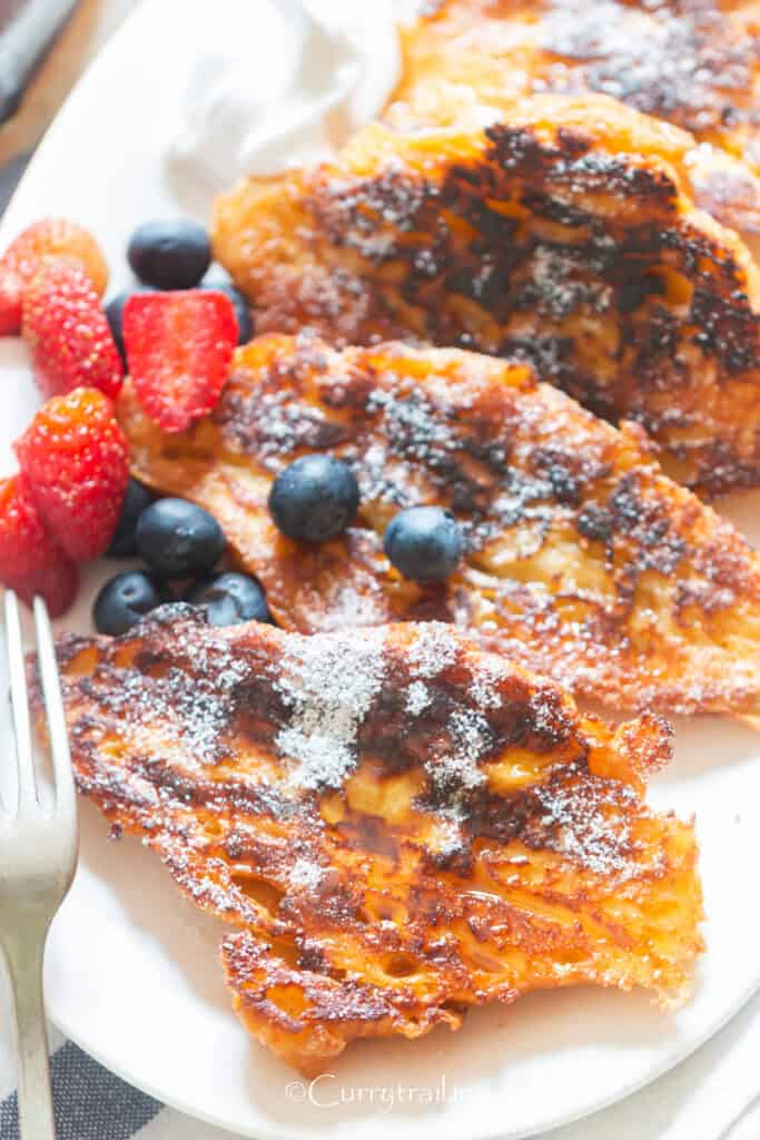 buttery croissant with maple syrup and berries.