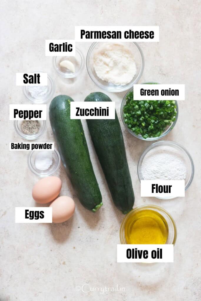 all ingredients for zucchini fritters arranged on a table.
