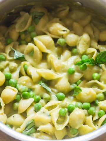 shell pasta along with peas in a large pot.