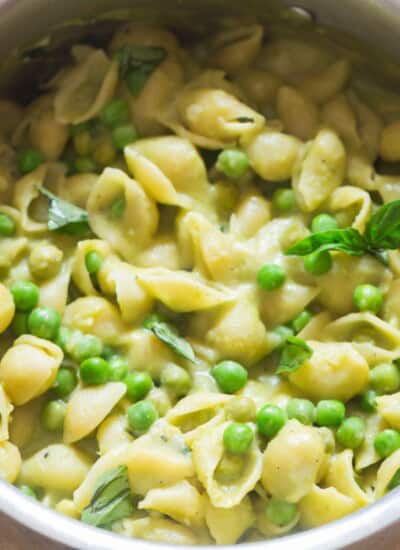 shell pasta along with peas in a large pot.