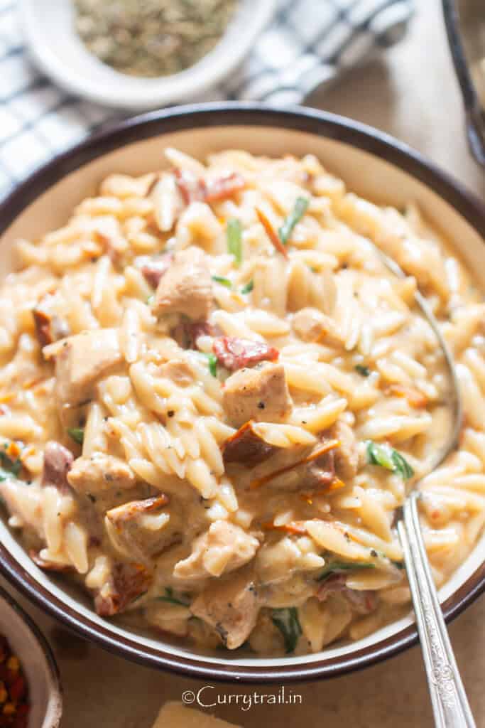creamy chicken with orzo pasta in a bowl.