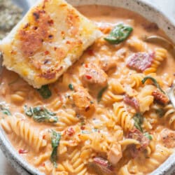 chicken soup in creamy sun-dried tomato sauce in a bowl.