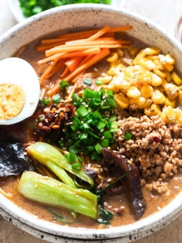 a bowl of ramen noodles in miso broth and toppings.