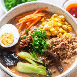 spicy miso ramen in umami broth with lots of toppings in a bowl.