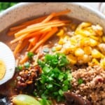 ramen in spicy miso broth with chicken and other toppings.