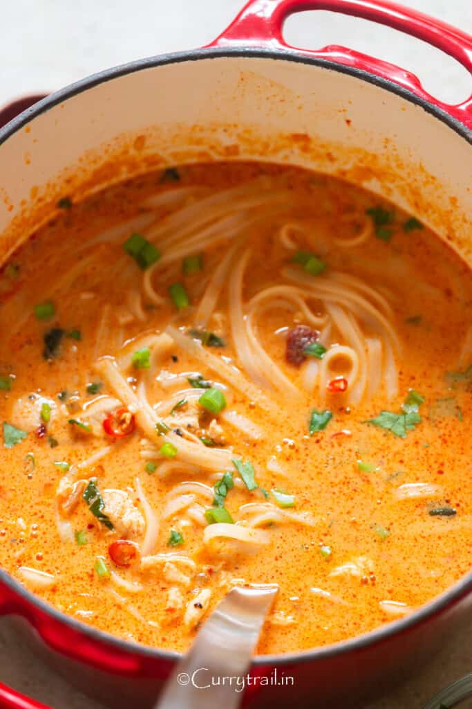 Thai soup with chicken and rice noodles in a bowl.