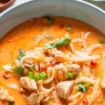 spicy chicken soup in a bowl with rice noodles.