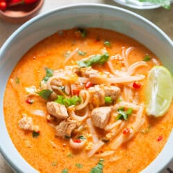 Thai soup with chicken and rice noodles in a bowl.