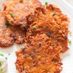 golden crispy Kartoffelpuffer arranged on a plate.