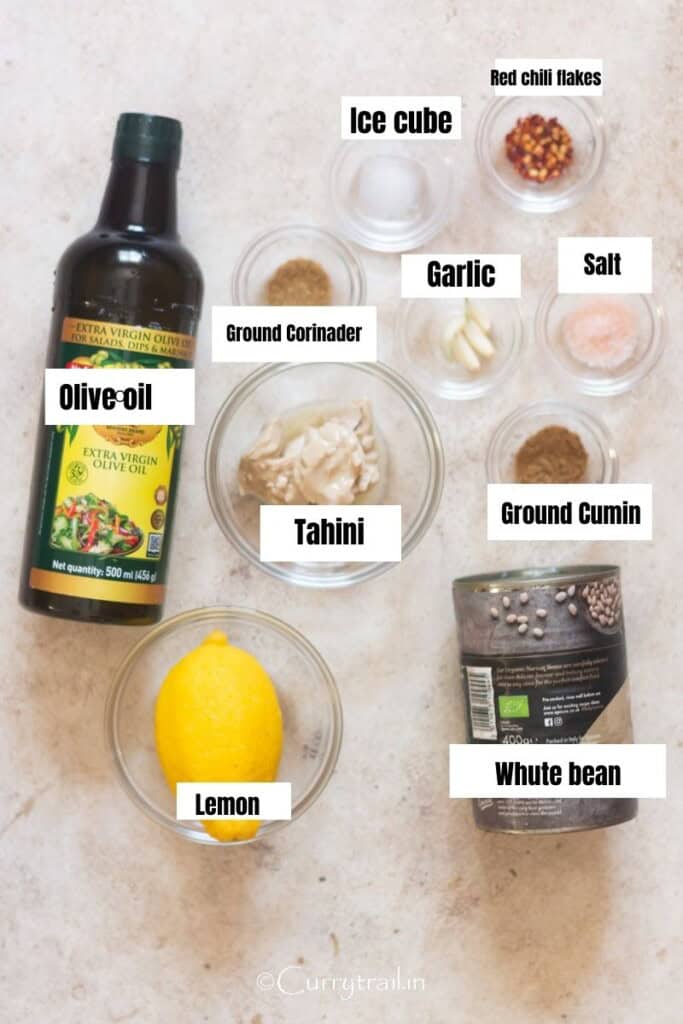 all ingredients for bean hummus arranged on a table.