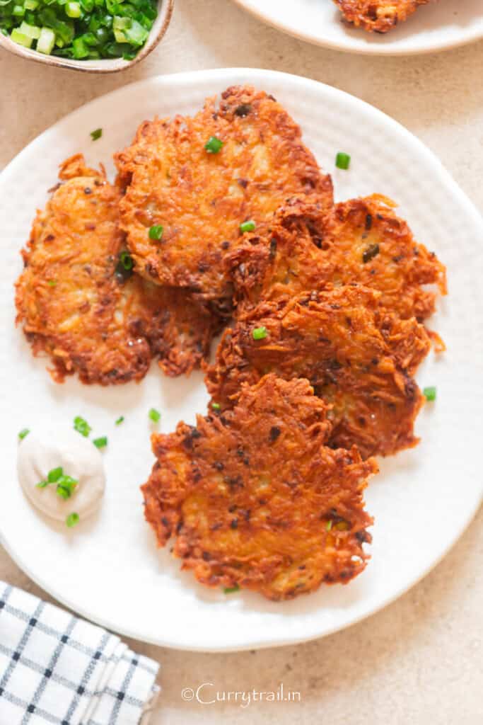 golden crispy savory potatoes made using grated potatoes.