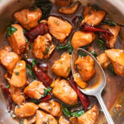 saucy chicken cooked in soy sauce chinese wine and sesame oil in a skillet.