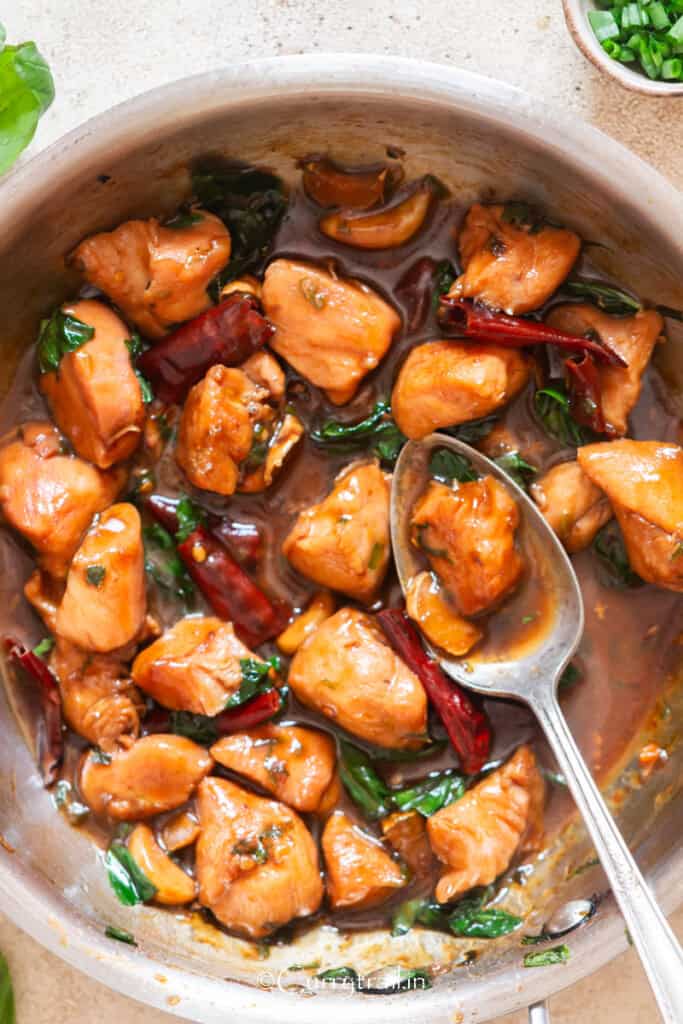 saucy chicken cooked in soy sauce chinese wine and sesame oil in a skillet.