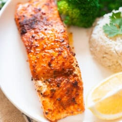 grilled cajun spiced salmon on a plate with cilantro lime rice.