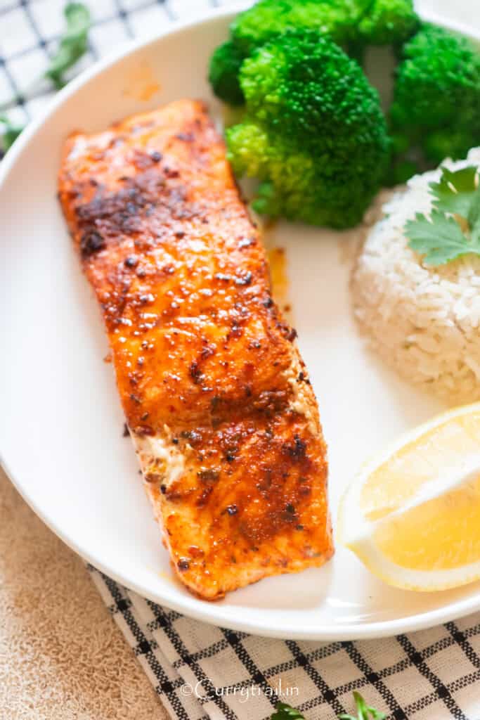 grilled cajun spiced salmon on a plate with cilantro lime rice.