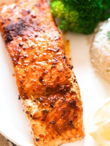 grilled cajun spiced salmon on a plate with cilantro lime rice.