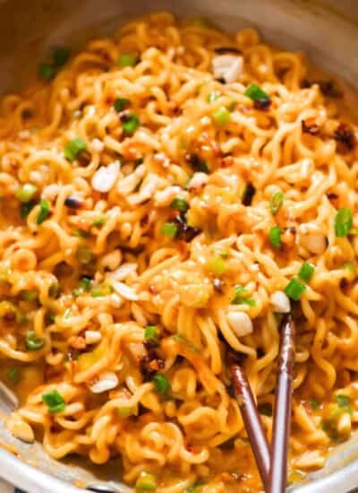 creamy spicy peanut butter ramen noodles cooked in a skillet.
