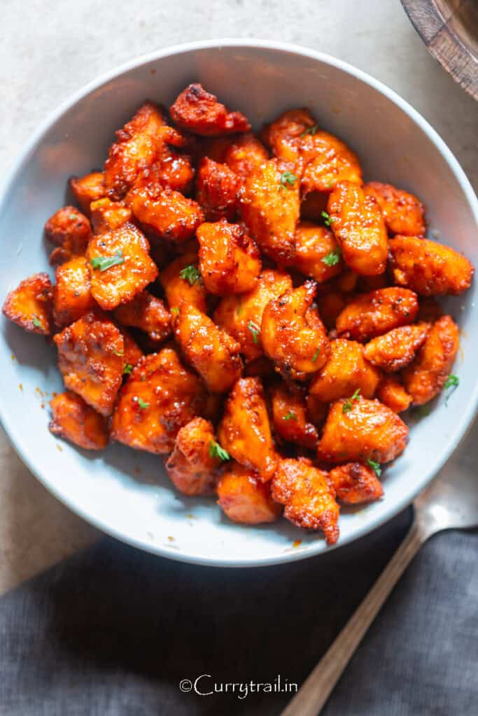 crispy, juicy salmon bites cooked in an air fryer in a bowl.