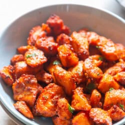 crispy, juicy salmon bites cooked in an air fryer in a bowl.