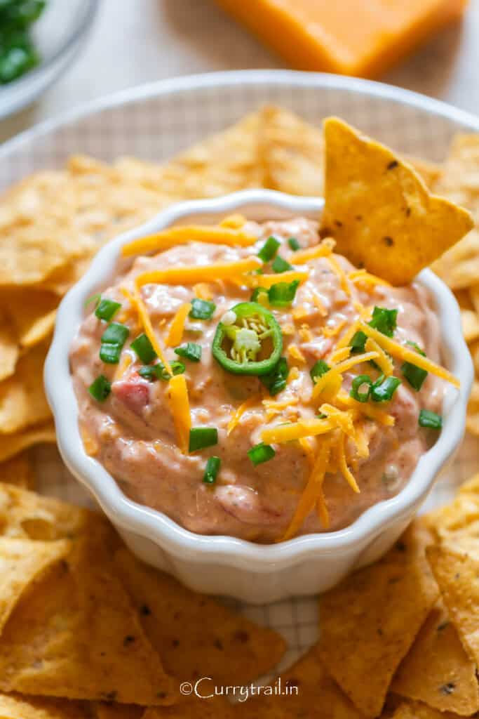 creamy boat dip served with nachos.