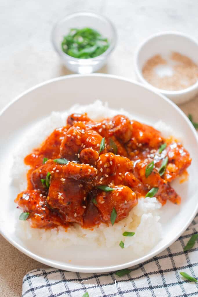 spicy crispy chicken coated in hot sauce served with rice.