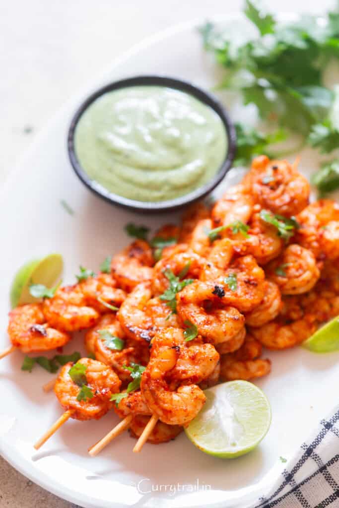 spicy grilled shrimp on bamboo skewers with avocado dip.