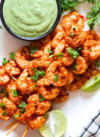 spicy grilled shrimp on bamboo skewers with avocado dip.